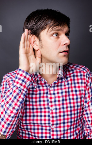 Man with hand on ear isolated over white background Banque D'Images