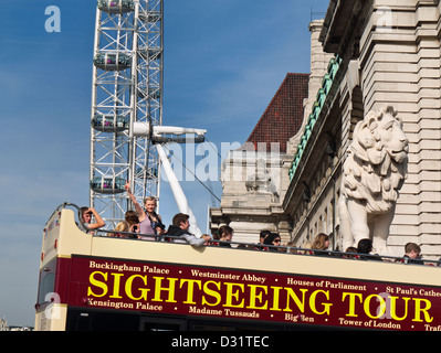 Staycation bus touristique à toit ouvert avec les touristes sur le pont de Westminster Avec London Eye derrière Londres Royaume-Uni Banque D'Images