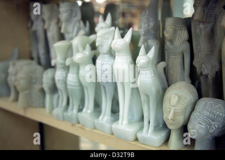 La sculpture sur pierre souvenirs de pharaons, des chats, des scarabées et des dieux en vente dans une boutique de cadeaux touristiques à Louxor Eqypt Banque D'Images