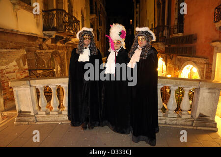 Venise, Italie. 7 février 2013. Les amateurs de carnaval dans la rue habillés de leurs plus beaux costumes et des masques à défiler autour de la Place Saint Marc, la nuit, pour célébrer le Carnaval de Venise en Italie. Le thème pour 2013 est de vivre en couleur. Banque D'Images