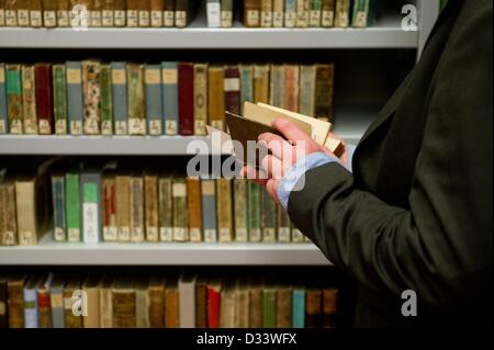 Un employé de la bibliothèque de la Duchesse Anna Amalia ressemble à un almanach le dépôt de la bibliothèque de Weimar, Allemagne, 08 février 2013. La bibliothèque de la Duchesse Anna Amalia juridiquement acquis Goldschmidt's almanac collection, qui se compose de volumes à partir de 2000 entre la 17e et 19e siècle. La collecte avait été classé en tant que butin et est considéré comme l'un des plus grands cas de restitution en allemand à la bibliothéconomie. Photo : MARC N.R.I.T. Banque D'Images