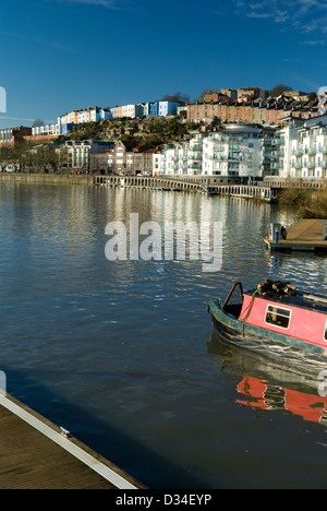 Bateau étroit sur port flottant avec les bâtiments colorés de condensats chauds dans la distance, Bristol, Angleterre. Banque D'Images