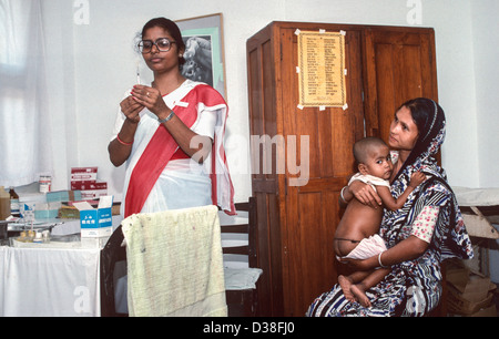 Enfant ayant une vaccination contre la polio dans le cadre de la campagne gouvernementale contre les maladies évitables. Service de nutrition pour enfants, Hôpital de Dhaka. Bangladesh Banque D'Images