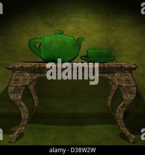 Théière vert avec une tasse sur une table Banque D'Images