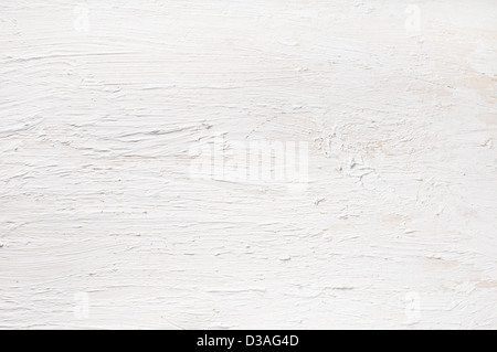 Détail de mur plâtré et peint en blanc. Sécheresse texture sur planche de bois. Banque D'Images