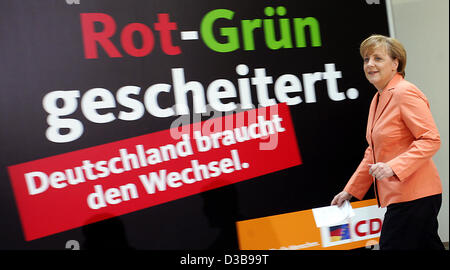 (Afp) - Présidente de la CDU Angela Merkel passe une affiche électorale de la CDU à Berlin, Allemagne, 05 juillet 2005. Merkel a commenté le manifeste électoral récemment libérés du SPD pour les élections générales de septembre. Banque D'Images