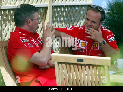 (Afp) - pilote de Formule 1 brésilien Rubens Barrichello (R) des entretiens avec le directeur technique de l'équipe Ferrari, Ross Brawn, sur le circuit Gilles Villeneuve, à Montréal, Canada, le 12 juin 2003. Le Grand Prix du Canada aura lieu le 15 juin. Banque D'Images