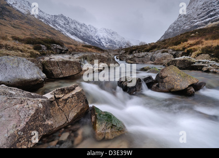 River Coe, Glencoe, avec la neige couverte de l'Aonach Eagach ridge dans l'arrière-plan Banque D'Images