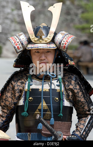 Un jeune samouraï dimanche portant un costume traditionnel de l'armure du guerrier pose pour une photo lors d'un festival au Château d'Odawara. Banque D'Images