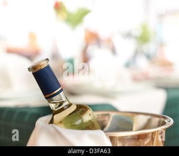 Bouteille de vin blanc froid dans la glace sur la table de restaurant Banque D'Images