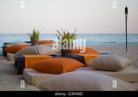 Coin bas mis en place sur la plage au coucher du soleil à Six Senses Zighy Bay, Oman Banque D'Images