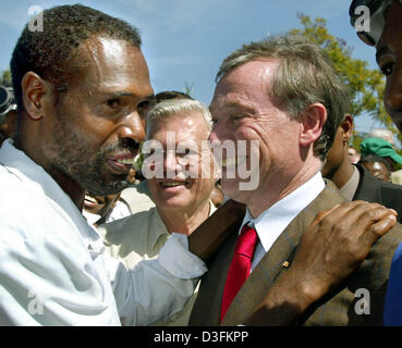 (Afp) - Un jeune homme se félicite le président allemand Horst Koehler (R) avec un petit câlin à l'acteur allemand Karlheinz Boehm (C) Centre de formation de l'organisation 'Menschen aide für Menschen" (les gens pour les gens) à Harar, en Ethiopie, le 14 décembre 2004. Dans le cadre de sa tournée de l'Afrique, Koehler est en Éthiopie pendant cinq jours. Banque D'Images