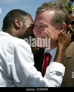 (Afp) - Un jeune homme se félicite le président allemand Horst Koehler (R) avec un petit câlin à l'acteur allemand Karlheinz Boehm son centre de formation de l'organisation humanitaire 'Menschen für Menschen" (les gens pour les gens) à Harar, en Ethiopie, le 14 décembre 2004. Dans le cadre de sa tournée de l'Afrique, Koehler est en Éthiopie pendant cinq jours. Banque D'Images