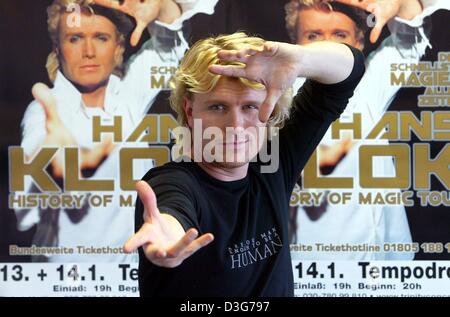 (Afp) - magicien néerlandais Hans Klok gestes devant son bureau d'affiches au cours d'une conférence de presse à Berlin, 11 novembre 2003. Son tour 2004 sera intitulée "L'histoire de Magic' et prendra le départ le 8 janvier 2004 à Francfort. Une partie de ses revenus seront reversés à l'UNICEF. Banque D'Images
