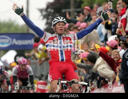 (Afp) - coureur norvégien Thor Hushovd (C) de l'équipe Crédit Agricole étend les bras et des acclamations qu'il remporte la 8e étape du Tour de France à Quimper, France, le 11 juillet 2004. Derrière lui, c'est Team T-Mobile's Erik Zabel (L) qui a pris la troisième place. La scène couvre une distance de 168 km de Lamballe à Quimper. Banque D'Images