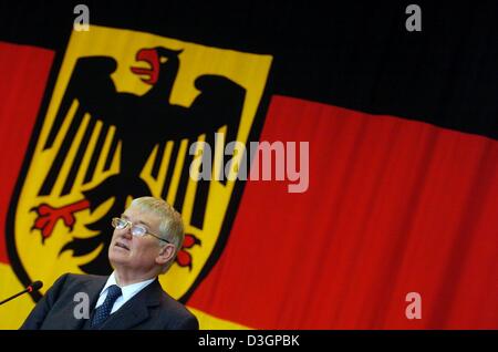 (Afp) - Le ministre de l'Intérieur allemand Otto Schily parle devant un drapeau avec l'aigle fédéral allemand à Wiesbaden, Allemagne, 26 février 2004. Banque D'Images
