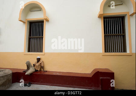 L'homme se reposant devant une mosquée, Vieille Ville, Mombasa, Kenya Banque D'Images
