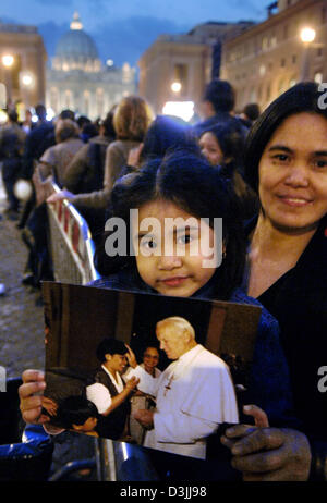 (Dpa) - Kimberly des Philippines montre une photo du Pape Jean Paul II en face de la Place Saint Pierre au Vatican, État de la Cité du Vatican, le 6 avril 2005. Jusqu'au 8 avril, la Basilique Saint Pierre est ouverte jour et nuit pour les visiteurs du monde entier de sorte qu'ils étaient en mesure de payer leur rendre hommage au défunt pape. Banque D'Images