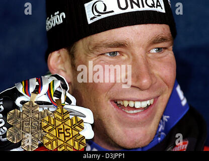 (Afp) - Le skieur Autrichien Benjamin Raich sourire alors qu'il présente ses médailles de bronze et d'or, après avoir remporté le deuxième run dans le slalom de ski alpin Combiné au Championnats du monde à Bormio, Italie, 03 février 2005. Raich a gagné l'or et le titre de champion du monde. Banque D'Images