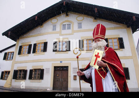 (Afp) - un homme habillé en père Noël pose devant la maison natale du pape Benoît XVI en Bavière, Marktl am Inn, Allemagne, le 23 décembre 2005. Le pape Benoît XVI, est né à la Chambre le 19 avril 1927. Photo Armin Weigel Banque D'Images