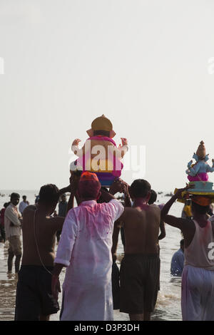 Les personnes à la cérémonie d'immersion du Seigneur Ganesha, Mumbai, Maharashtra, Inde Banque D'Images