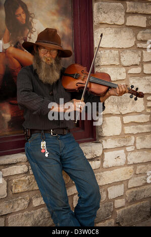 Texas fiddler avec barbe et floppy hat joue son violon/violon sur un coin de rue. Banque D'Images