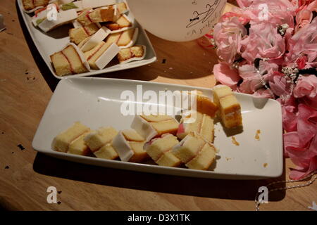 Le gâteau coupé en tranches, présentés sur un côté d'un ballon et d'un bouquet de fleurs. Banque D'Images