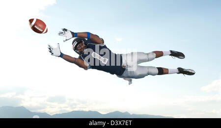 African American football player catching ball Banque D'Images