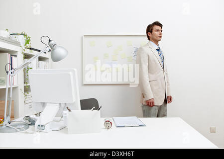 Stock photo d'un homme debout par son bureau 24 Banque D'Images