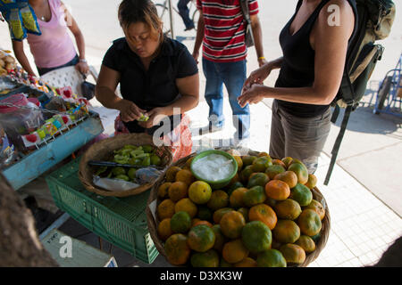 Les visiteurs et les voyageurs d'acheter des oranges et vert magoes à partir d'un étal au Nicaragua. La culture du café des hautes terres du Nicaragua Banque D'Images