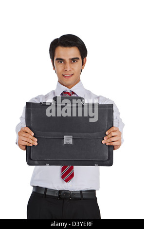 Businessman showing a bag and smiling Banque D'Images