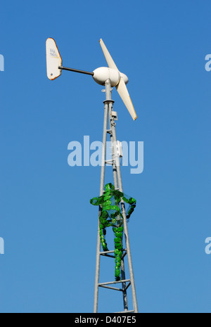 Éolienne sur le toit de l'ancien bâtiment du bureau de poste, dans la région de Thomas Street, Manchester avec un homme vert l'ascension de la structure. Banque D'Images