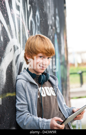 Boy wearing Headphones using Tablet PC, Mannheim, Baden-Wurttemberg, Germany Banque D'Images