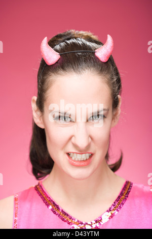 Portrait of Woman Wearing Devil Horns et Making Faces Banque D'Images