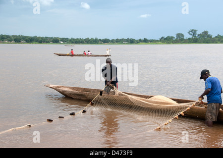 République centrafricaine. Août 2012. Bangui. hommes transportant dans des filets de pêche à leur canot. Banque D'Images