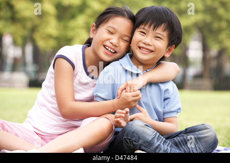 Portrait of Chinese Boy and Girl Sitting in Park Ensemble Banque D'Images