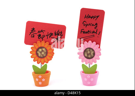 Carte papier written 'Happy Spring Festival bilingue des mots en anglais et en chinois sur sun flower pot clip Banque D'Images