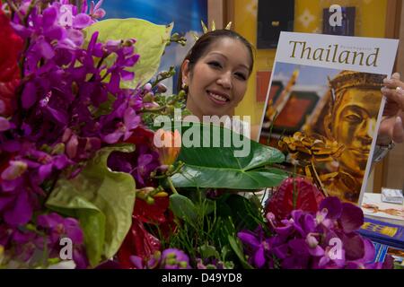 Berlin, Allemagne. 9 mars, 2013. Une jeune femme sourit et pose d'un catalogue à la juste position de la Thaïlande au cours de la Foire Internationale du Tourisme (ITB, Internationalen Tourismus Börse) à Berlin, Allemagne, le 9 mars 2013. L'Indonésie est le partenaire de l'ITB en 2013. Photo : Soearen le Stache/dpa/Alamy Live News Banque D'Images