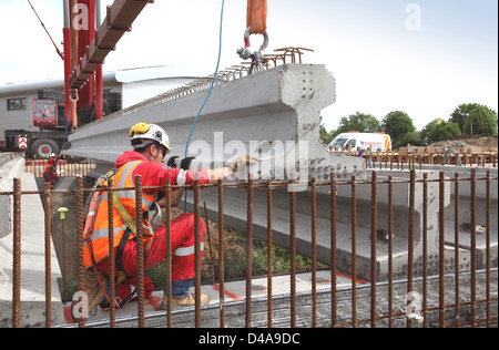 17m de longueur des poutres en béton précontraint sont mise en place pour soutenir une nouvelle route pont enjambant une rivière ponceau à Woking, Royaume-Uni Banque D'Images