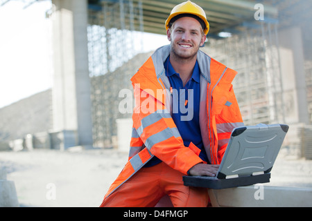 Worker using laptop sur place Banque D'Images