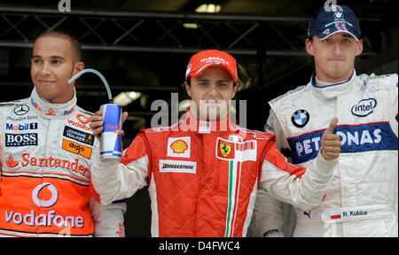 Pilote de Formule 1 brésilien Felipe Massa, de Ferrari (C) pose avec la pilote de F1 Lewis Hamilton de McLaren Mercedes (L) et le Polonais Robert Kubica F1 de BMW Sauber (R) après il a inscrit le meilleur temps de qualification à Valencia Street Circuit dans Valencia, Espagne, 23 août 2008. La formule un Grand Prix d'Europe aura lieu le dimanche 24 août 2008. Photo : Carme Banque D'Images