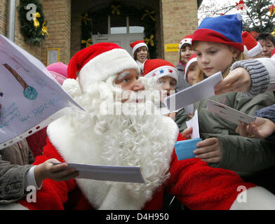 Santa Claus est accueilli par les enfants comme il arrive pour l'ouverture de l'office de poste de Noël dans Himmelpfort, Allemagne, 10 novembre 2008. Jusqu'au 24 décembre 2008 le Père Noël, avec l'aide de 20 assistants, répondra à lettres d'enfants à la maison de l ?invité ? Dans la région de Flensburg. L'année dernière, 280 000 enfants du monde entier ont écrit des lettres au Père Noël en Himmelpfort. Photo : Ber Banque D'Images