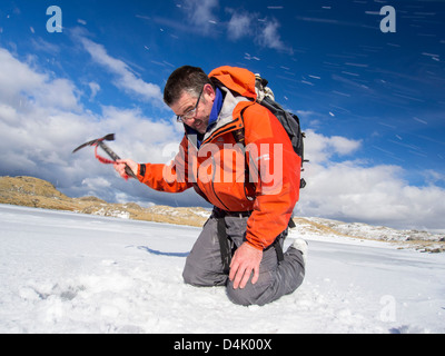 Un grimpeur sur Tarn arrosage à la tête de Borrowdale, gelé, à l'égard Glaramara, Banque D'Images