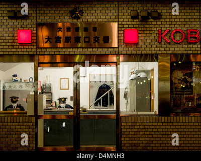 Deux policier portant des masques sur service de nuit à la réception dans un Koban, un poste de police local, en Omiya, le Japon. Banque D'Images