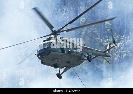 Un hélicoptère Mi-17 de l'Armée de l'air avec godet bambi sur un feu de forêt en Bulgarie. Banque D'Images