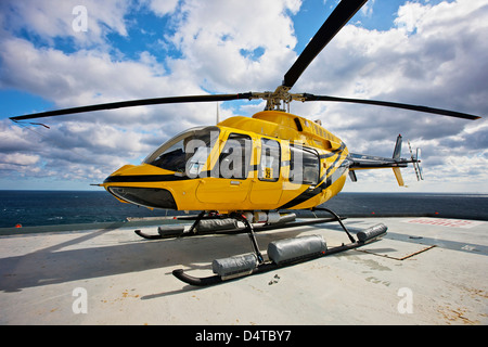 Un hélicoptère Bell 407 sur l'hélisurface de l'utilitaire d'une plate-forme pétrolière. Banque D'Images