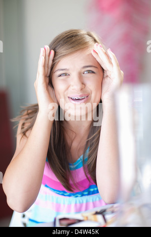 Teenage girl playing peek-a-boo Banque D'Images