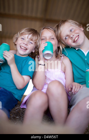 Les enfants de boire de soude dans garage Banque D'Images