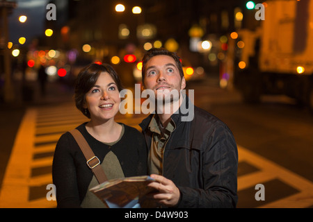 Couple reading plan de ville de nuit Banque D'Images