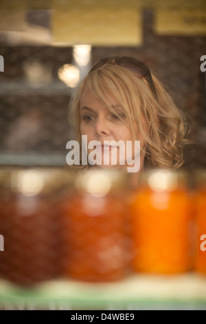 Woman shopping for jam des épiceries. Banque D'Images